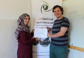 teacher giving student certificate