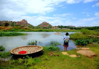 woman gazing at water in Hampi