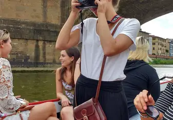 SIA took us on a boat ride down the Arno, and I was captured in my element. Taking photos!