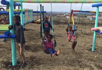 Playing with kids on the playground we made. 