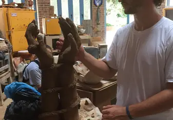 Dylan finishing his ceramics sculpture.