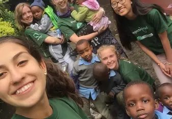 group photo of volunteers and children