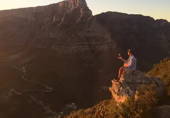 man sitting on cliff