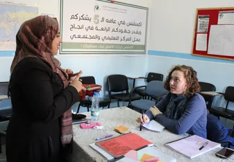 teacher and student at table