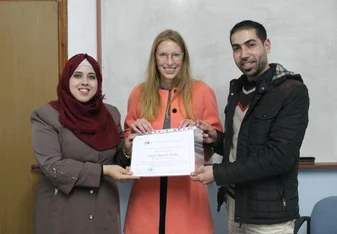teacher and student holding up award certificate