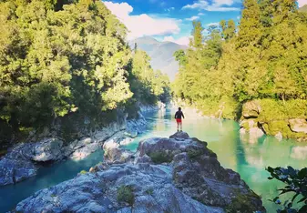 woman on rocks in river