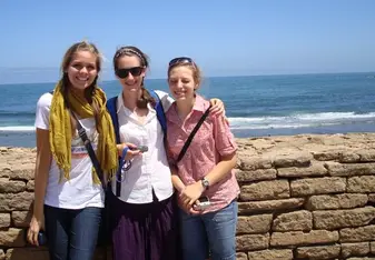 girls smiling by the ocean