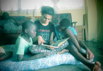woman reading to two children