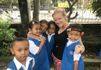 photo of woman with young students