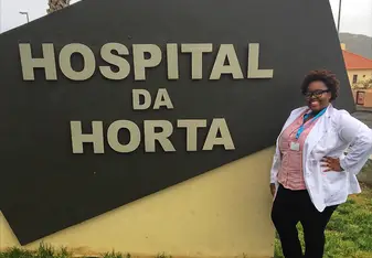 woman standing by hospital sign