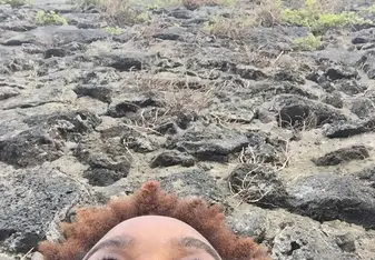 woman lying on rocks