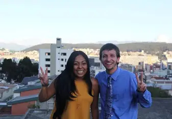 male and female showing peace sign