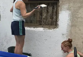 My mom and I painting the main building.