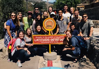 group photo at equator in ecuador