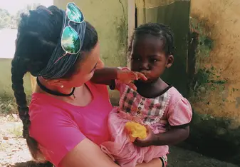 young woman holding small child