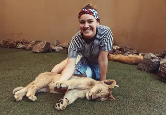 woman with lion cub