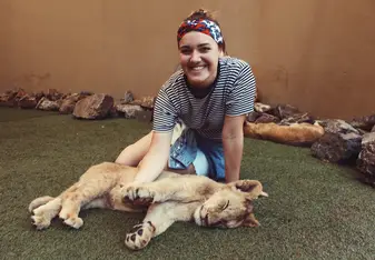 woman with lion cub