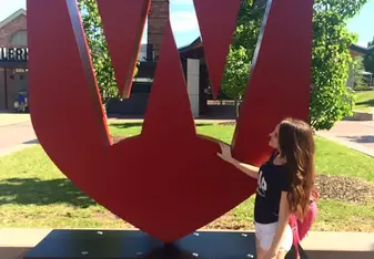 female at Western Sydney University sign