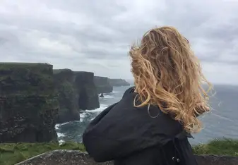 girl looking at Cliffs of Moher