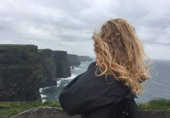 girl looking at Cliffs of Moher