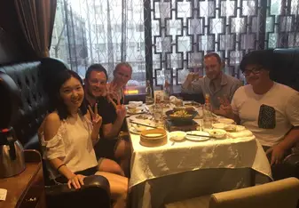 men and women eating dinner 