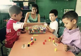 Ms. Perla (former SJBA student, and now Prepa Teacher) developing fine motor skills with SJBS students.