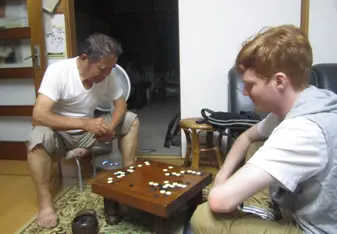 Playing igo with host family member