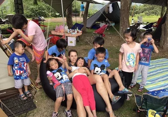 Girl surrounded with children.