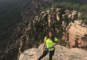 Girl standing at a cliff.