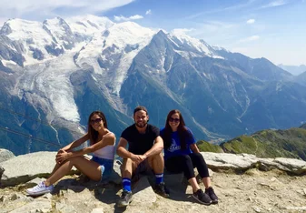 Three persons at a mountain in the Alps.