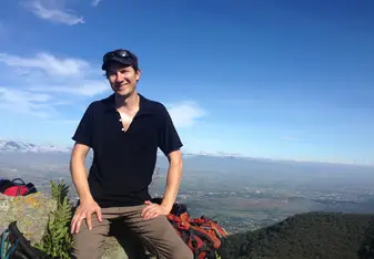 male headshot on a mountain