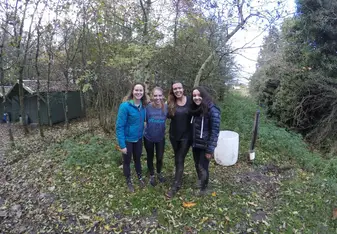 Four women in the woods.