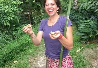 A woman holding a fruit.