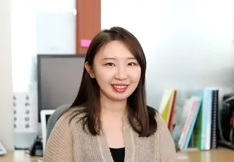 Woman inside an office posing for a photo