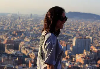 Girl overlooking a city view.