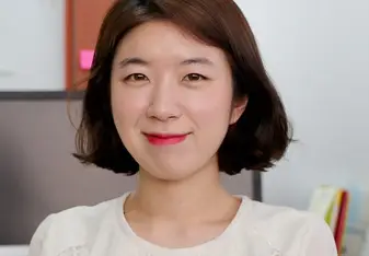 A lady smiling for a photo.