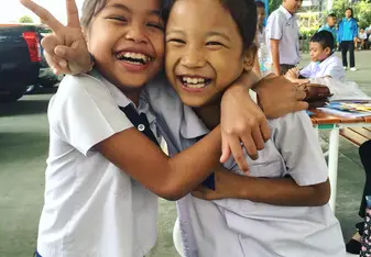 Two students smiling.
