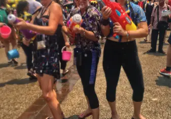Three women holding water guns.