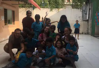 in the court yard of the school with other volunteers