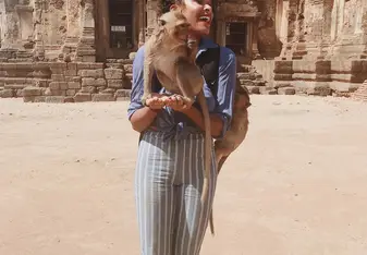 Picture of me in Lopburi, Thailand holding wild monkeys.