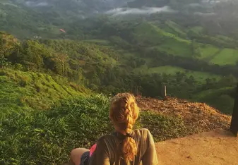 A woman gazes at the mountains.