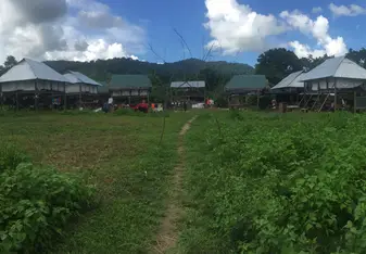 Wooden houses at a wide field.
