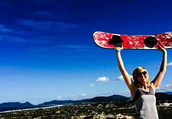 a woman holding a sandboard