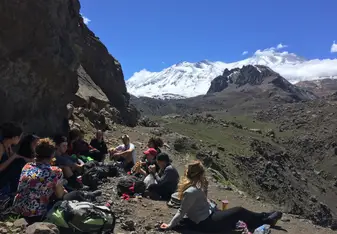 Hikers eating lunch overlooking mountains