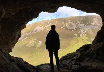 This is a picture of me looking out of a cave in Ullapool. 