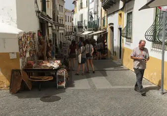 A picture of a street in Evora with all of the local street shops!