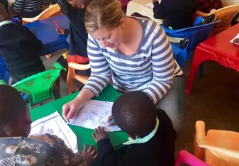 young woman teaching little kids