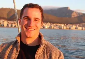 Image of student, backed by Table Bay and the Cape Town skyline