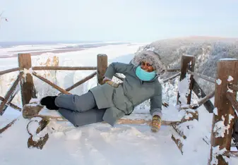 Relaxing on a snow covered bench atop the Lena Pillars
