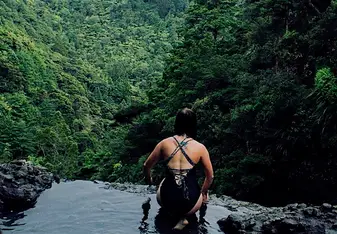 woman having a swim on a falls